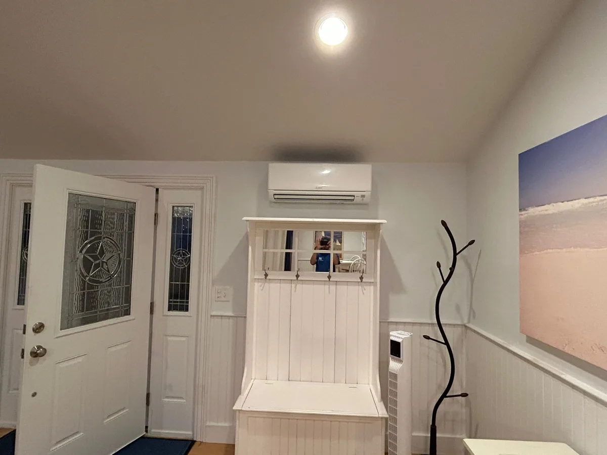 Wall-mounted mini split in residential entryway