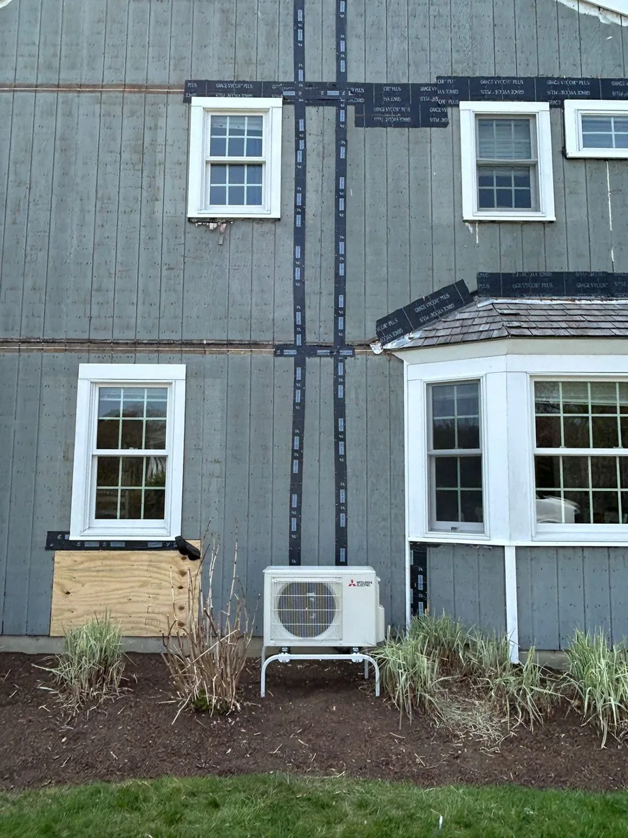 Outdoor heat pump condenser installed at New England home
